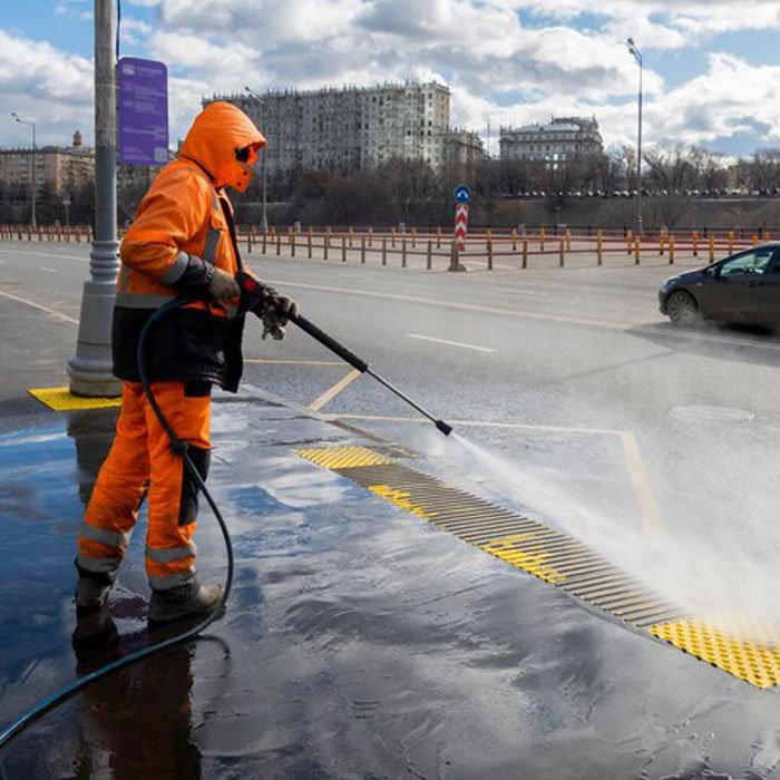 cleaning car parking area with pressure wash