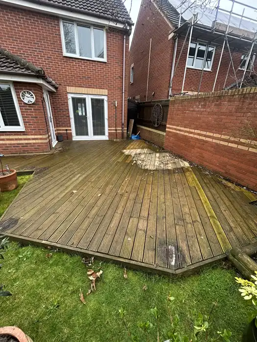 Wooden garden decking covered in green algae and grime before professional pressure washing in Brislington, Bristol