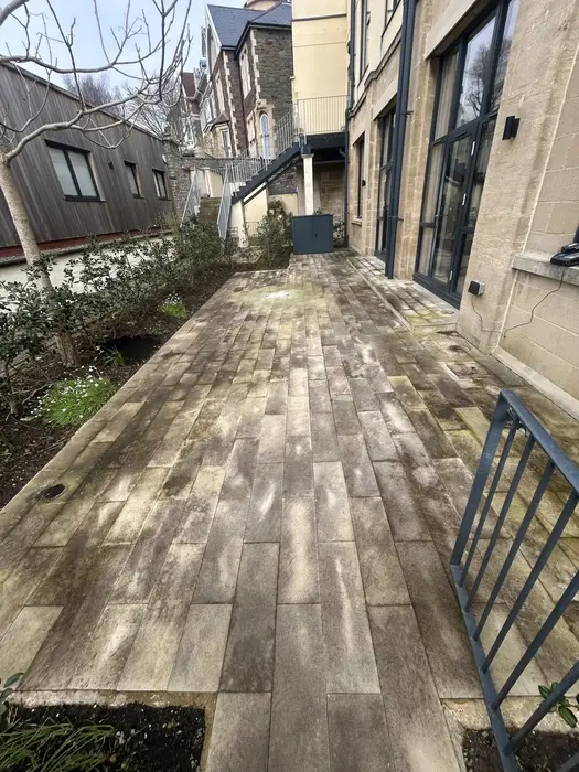 Garden patio with heavy algae, moss and weed growth before professional pressure washing in Redland, Bristol